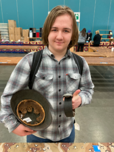 Young Man Buying British Cavalry Helmets at the Show of Shows 2023