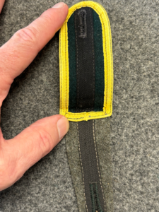 reinforced button hole on a german shoulder strap (green variation)
